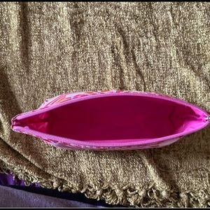 Pink and orange makeup bag with a groovy print